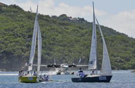 V.I.'s Team Island Sol, skippered by Nikki Barnes, (left) and Puerto Rico's Jorge Santiago sail ahead of a seaplane landing in St. Thomas harbor. V.I.'s Team Island Sol, skippered by Nikki Barnes, (left) and Puerto Rico's Jorge Santiago sail ahead of a seaplane landing in St. Thomas harbor.